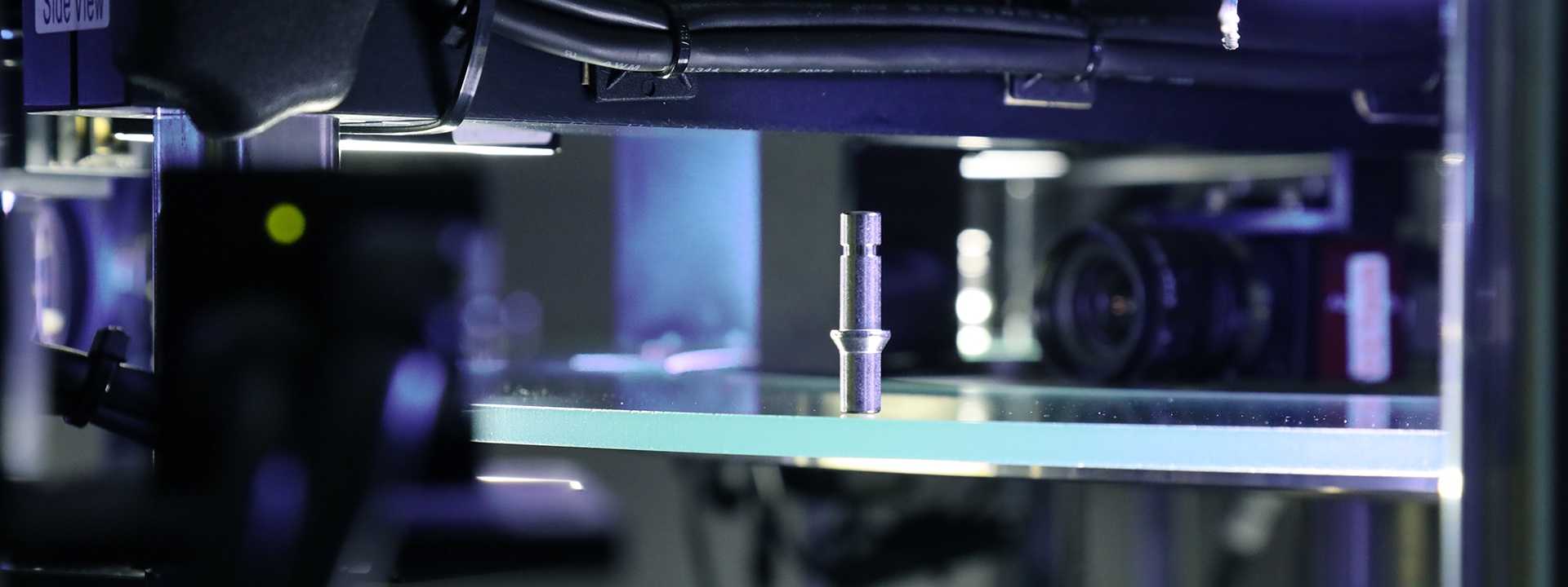 Metallisches Präzisionsteil in einer optischen Prüfanlage zur Qualitätskontrolle in der industriellen Fertigung.